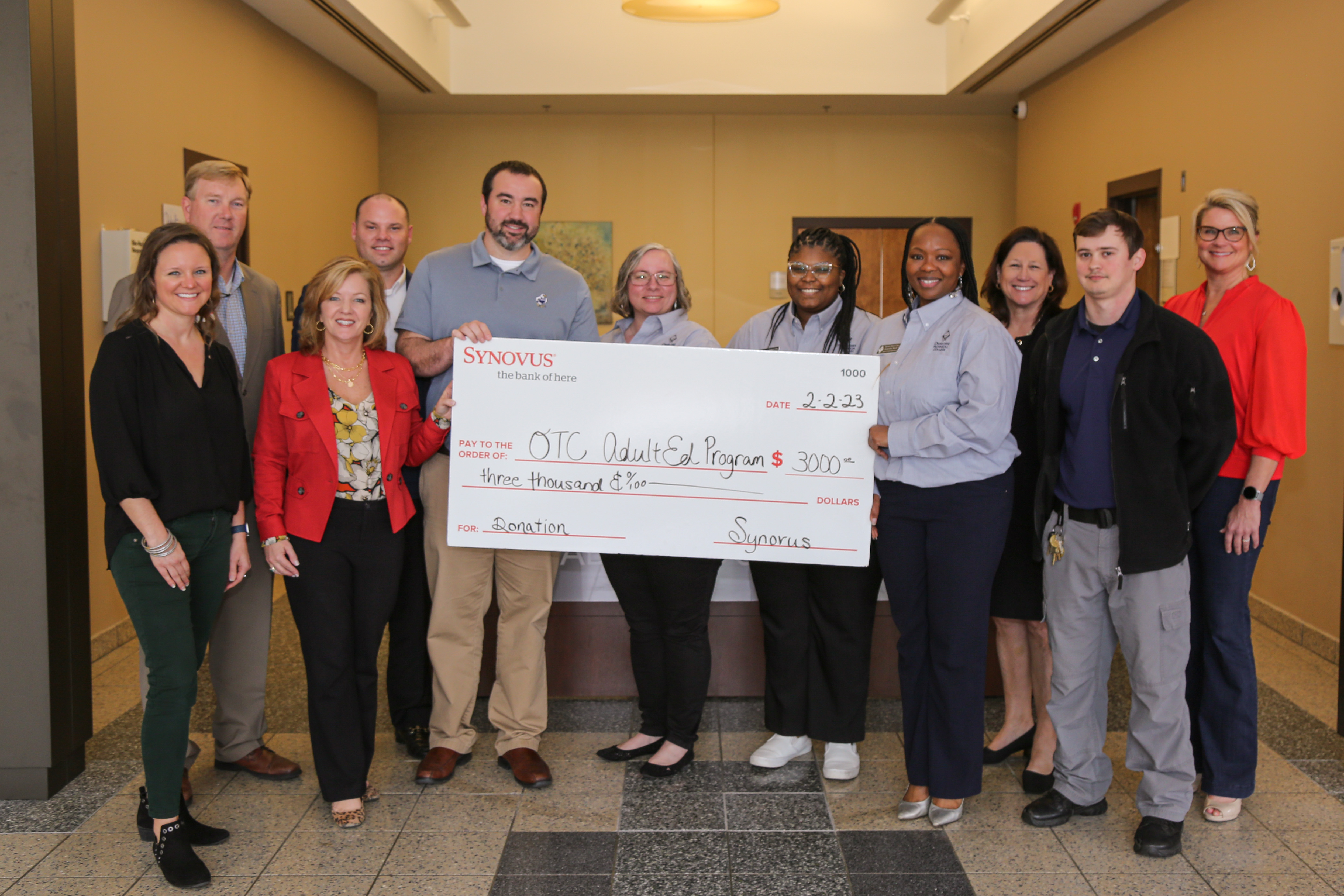 OTC's Adult Education Team with Synovus Bank accepting Donation Check