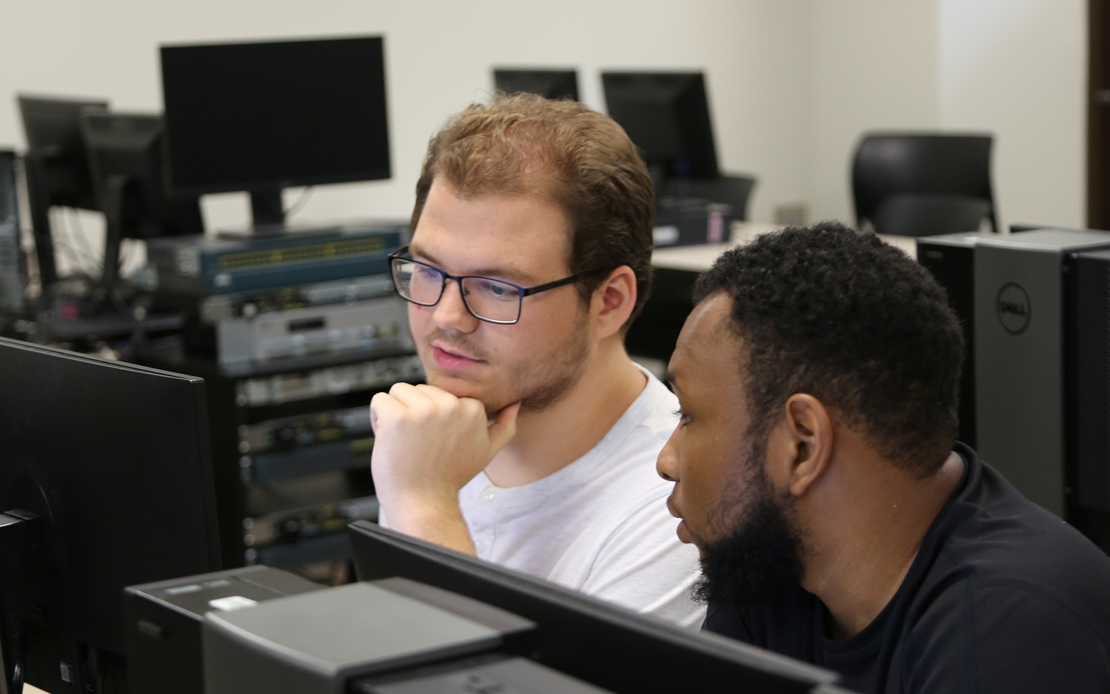 two cybersecurity students at the computer
